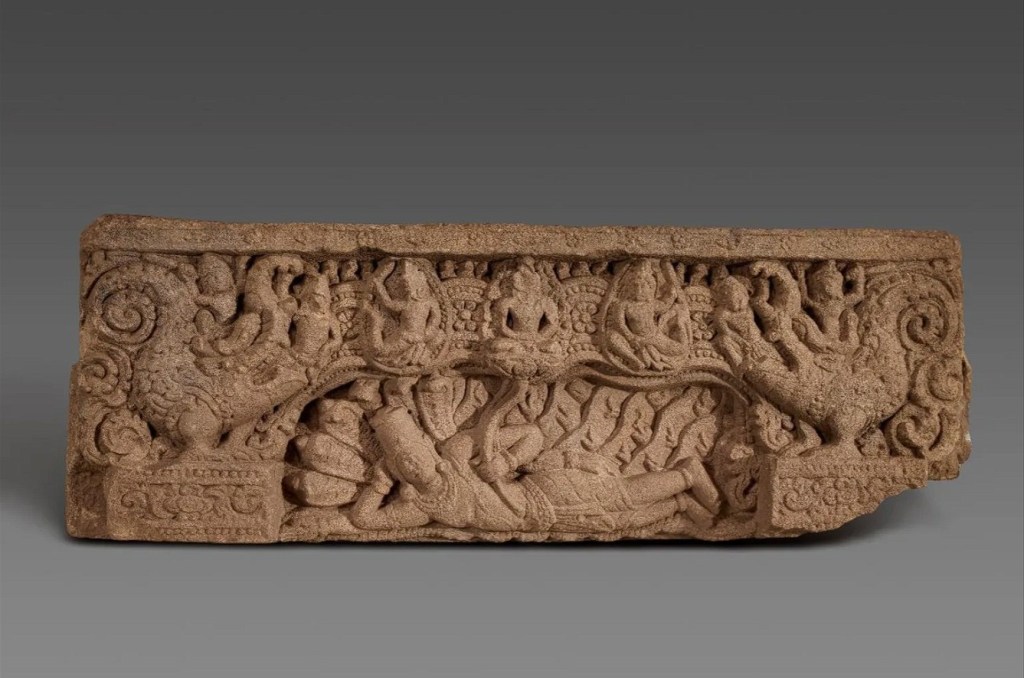A carved sandstone relief depicting deities and mythological creatures, showcasing intricate details and symbolism.