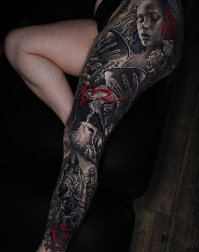 A detailed tattoo on a person's leg featuring various elements including a woman's face, roses, and a horse, with accents of red.