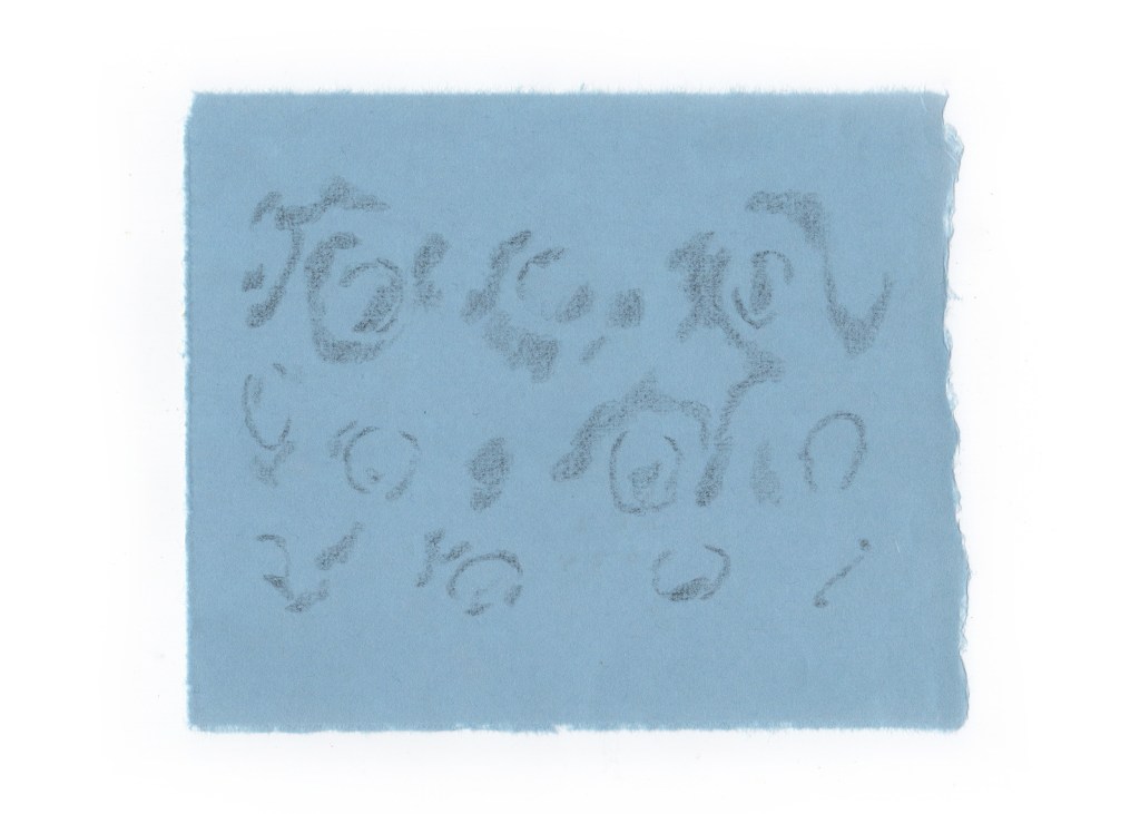 A light blue piece of paper with faint, abstract pencil markings resembling swirls and circular shapes.