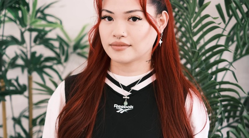 Professional portrait of Greta, known as Tatmegreta, resident junior tattoo artist specializing in fine line, romantic, and whimsical tattoos at Something Cool Tattoo in Edmonton, Canada.