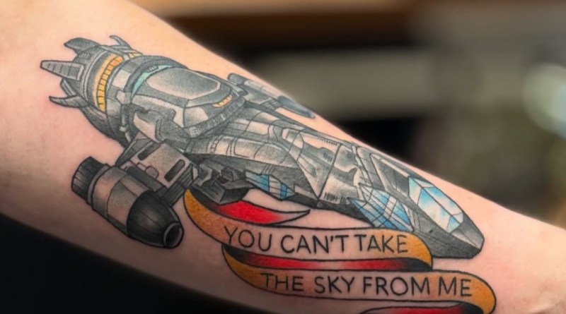 Jason Tritten tattooing a vibrant American Traditional Serenity spaceship from Firefly at Revolt Tattoos Fashion Show Mall Las Vegas