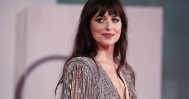 Dakota Johnson poses in a cream Valentino gown at the 2026 TIME100 Gala in New York, showcasing her elegant red carpet look