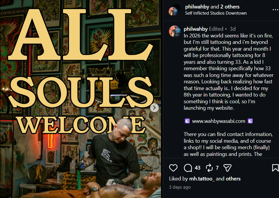 A tattoo artist working on a client's arm in a vibrant tattoo studio filled with artwork and neon signs. The words 'ALL SOULS WELCOME' are prominently displayed.