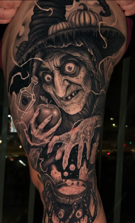 A detailed tattoo of a malevolent witch with exaggerated facial features, wearing a pointed hat, holding an apple and a potion bottle, with a bubbling cauldron at her feet.