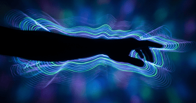 Silhouette of a hand with swirling neon blue, purple, and green light waves around it