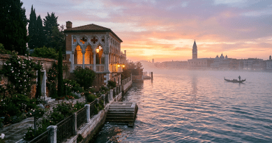 Gondola on Venetian canal at sunset with historic buildings and garden