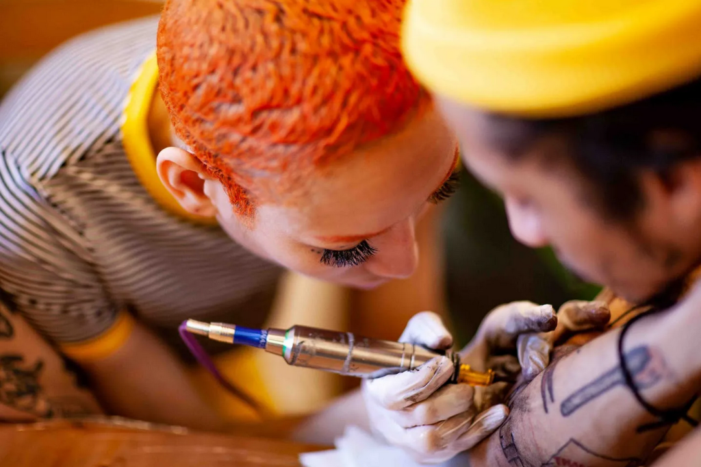 Close-up of professional tattoo equipment used in apprenticeship training programs.