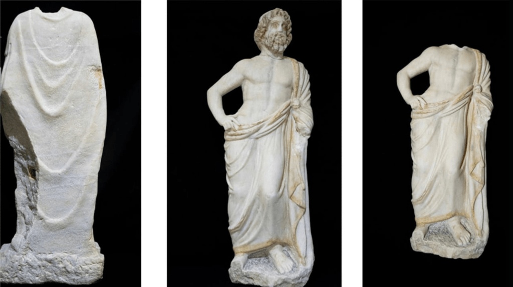 Three ancient marble statues from Alexandria excavations showing draped figures, likely depicting Greek and Roman gods Bacchus and Asclepius, discovered in Muharram Bek district in 2026.

