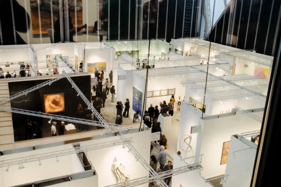 Crowded contemporary art fair booths with visitors at The Shed in Hudson Yards during Frieze New York 2026.