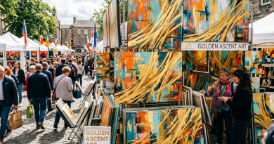 Booth displaying vibrant abstract paintings with gold, teal, and orange colors at an outdoor art market