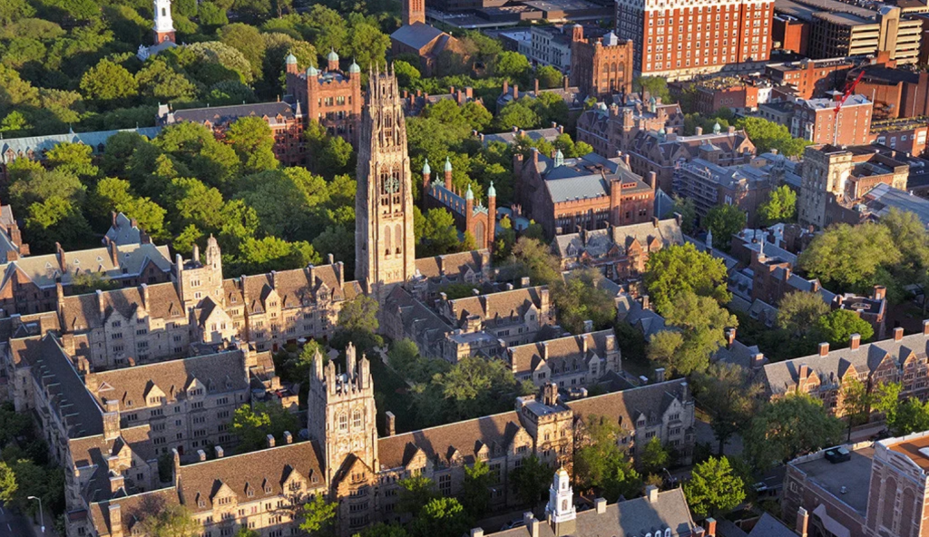 Expansive view of Yale’s historic Gothic architecture and green spaces, highlighting a major institution affected by proposed federal rules.