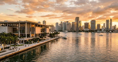 Miami skyline and waterfront promenade beneath a glowing sunset