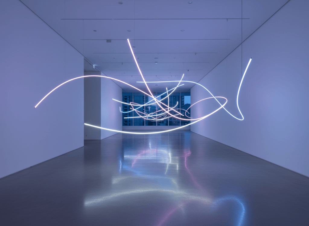 Gallery interior with abstract neon light sculpture glow